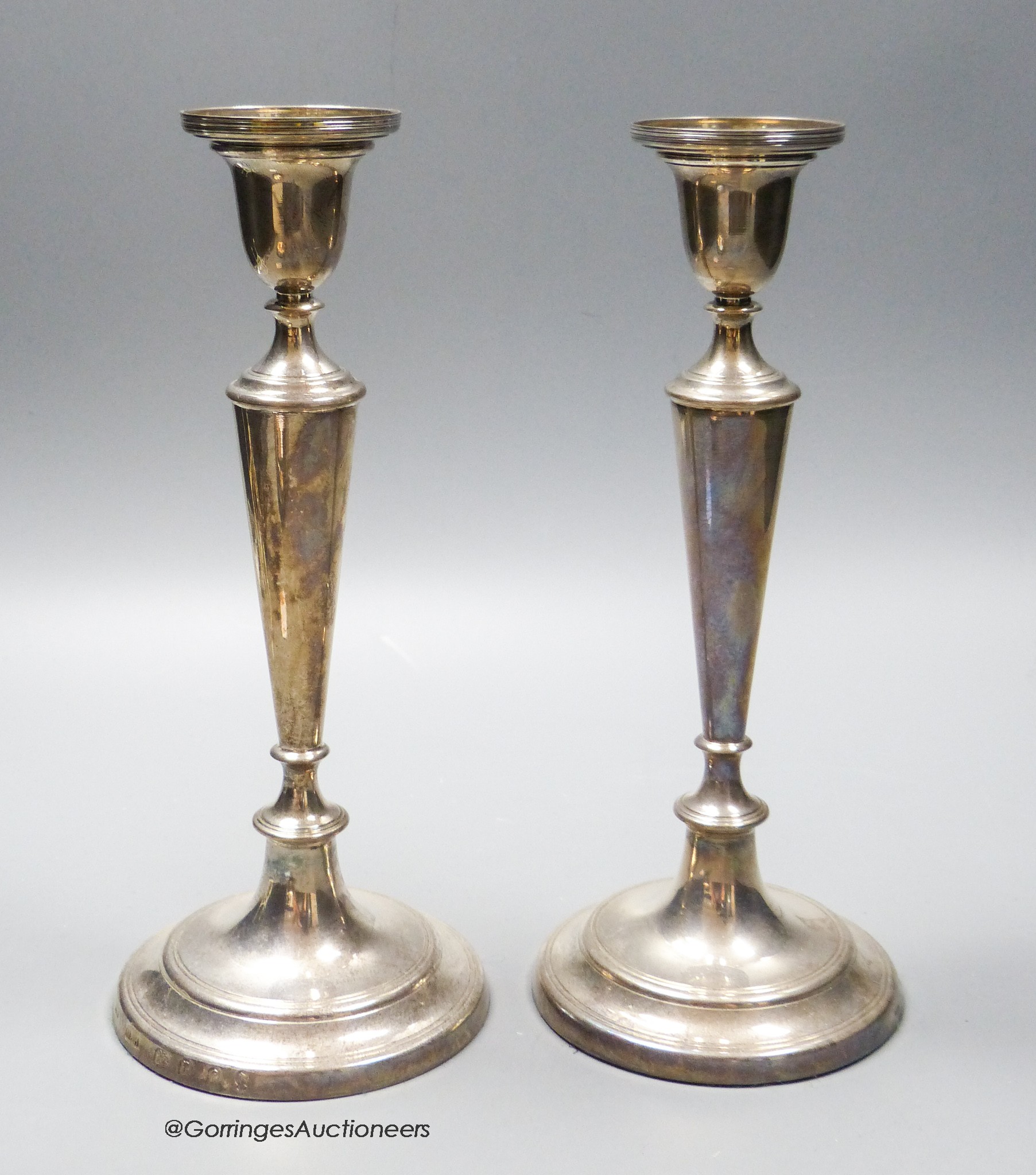 A pair of modern silver candlesticks, London, 1977, 23.1cm, weighted.